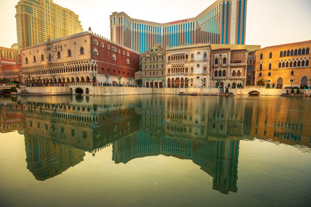 Macau, China - December 9, 2016: Venetian Casino and luxury mall reflecting in the lake at sunset in Cotai Strip. The Venetian Macao is modeled on its sister casino resort The Venetian Las Vegas.のeditorial素材