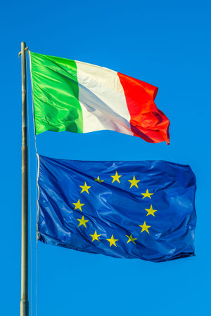 Italy flag and Europe flag waving together in isolated the blue sky background. Concept for...