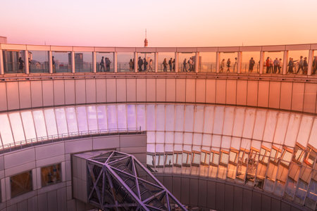 Osaka, Japan - April 28, 2017: Unidentified people on Floating Garden Observatory, Kita-ku district at twilight. A circular rooftop observation deck connecting the twin towers of Umeda Sky Building.のeditorial素材