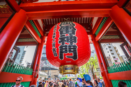 Tokyo, Japan - April 19, 2017: famous giant red lantern Kaminarimon Gate of Senso-ji Temple in Asakusa area. The Japanese word on the lantern means THUNDER GATE. Crowd of tourists on background.のeditorial素材