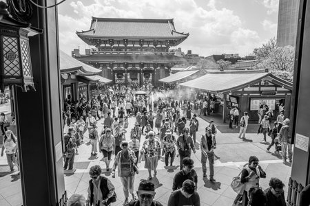 Tokyo, Japan - April 19, 2017: many people at north face of Hozomon Gate of Buddhist Temple Senso-ji, Asakusa, the oldest temple in Tokyo from main hall of Kannon Temple. Black and white pictures.のeditorial素材