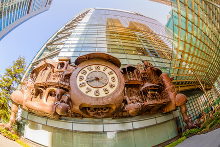 Tokyo, Japan - April 20, 2017: fisheye view of Ghibli clock in front of Nittele Tower (Nippon Television headquarters), Minato ward. The victorian steampunk clock icon of Shimbashi District.のeditorial素材