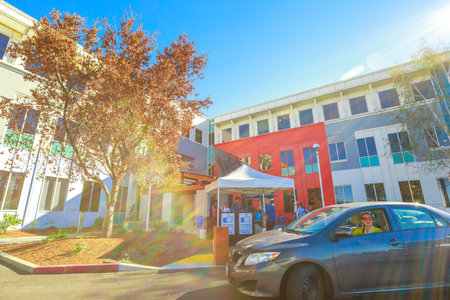 Mountain View, CA, United States - August 15, 2016: vallet parking lot with keepers at the entrance of Facebook headquarter, the world leader social network company. Typical LIKE logo signboards.のeditorial素材