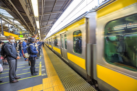 Tokyo, Japan - April 17, 2017: Chuo Line for Akihabara, the yellow line of JR Line, a rail service that crosses east-west Tokyo downtown, arriving at Shinjuku Station, Tokyos main station.のeditorial素材