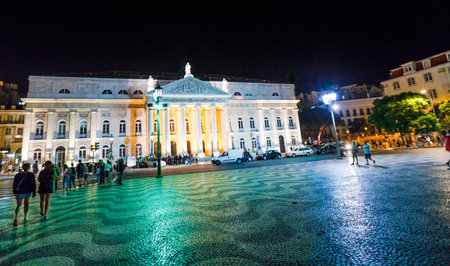 Lisbon, Portugal - August 24, 2017: The National Theater D. Maria II illuminated by night in Praca Dom Pedro IV or Rossio Square in Lisbon downtown.Rossio Square is a popular place for evening partiesのeditorial素材