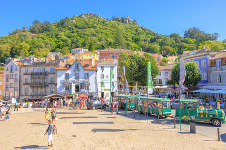 Sintra, Portugal - August 8, 2017: beautiful view of Castle of the Moors on top of a hill above Sintra from Amelia Square and Green Tourist Train in Historic Centerのeditorial素材