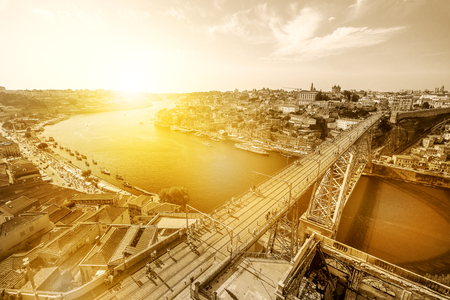 Aerial view of iconic Dom Luis I on Douro River from Miradouro da Serra do Pilar at Vila Nova de Gaia, Porto, Portugal. Picturesque urban cityscape. Sepia color shot with sunset light.の写真素材