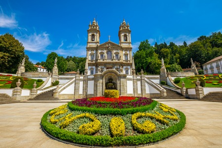 The spectacular facade of the Bom Jesus do Monte Sanctuary in neoclassical style surrounded by flowered gardens in a sunny day. Tenoes near Braga, north of Portugal, Europe.の写真素材