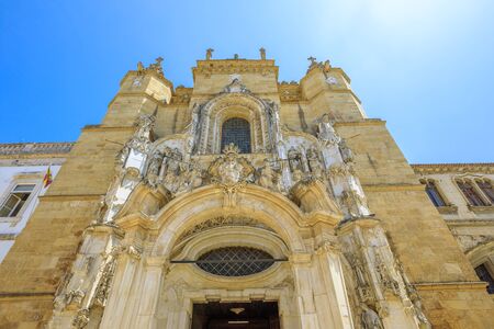 Bottom view of ancient Santa Cruz Monastery facade, historic center of Coimbra, Portugal, in a sunny day, blue sky. The Church of Santa Cruz is a famous landmark and touristic attraction in Coimbra.の写真素材