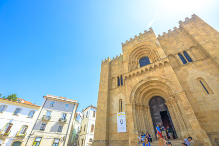 Coimbra, Portugal - August 14, 2017: tourists in front of Old Coimbra Cathedral. Se Velha de Coimbra, is one of most important romanesque buildings in Central Portugal in university town of Coimbra.のeditorial素材