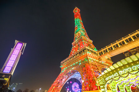 Macau, China - December 8, 2016: Perspective view of colorful Macau Eiffel Tower of The Parisian, a luxury Resort Hotel Casino in Cotai Strip Christmas holidays shines bright at night.のeditorial素材