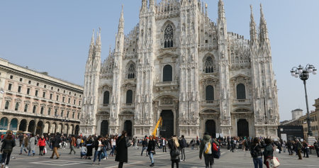 MILAN, ITALY- MARCH 7, 2017: people in Piazza Duomo square of Famous Milan Dome Cathedral facade. Tourists walking and taking pictures in fashion capital Milano.のeditorial素材
