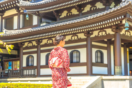 Kamakura, Japan - April 23, 2017: woman wearing japanese kimono in front of Kannon-do or Main hall of Hase-dera Temple in Kamakura. Japanese culture and lifestyle. Spring season.のeditorial素材