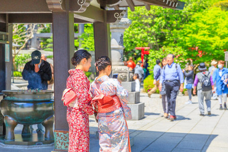 Kamakura, Japan - April 23, 2017: Japanese women wearing Japanese traditional kimono take selfie at Hase-dera in Kamakura. Hase-dera Buddhist temple is famous for housing a massive statue of Kannon.のeditorial素材