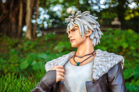 Hong Kong, China - December 5, 2016: portrait of Chan Lok-kwans statue in zoom edition with Combination of leaves background in Hong Kong Avenue of Comic Stars, Kowloon Park,Hong Kongのeditorial素材