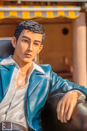 Hong Kong, China - December 5, 2016: Hui Lok close up edition, statue of famous characters, in Hong Kong Avenue of Comic Stars, Kowloon Park. Urban skyline background of Tsim Sha Tsui.のeditorial素材