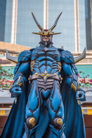 Hong Kong, China - December 5, 2016: Lord Dragon, statue of famous characters, in Hong Kong Avenue of Comic Stars, Kowloon Park. Urban skyline background of Tsim Sha Tsui District.のeditorial素材