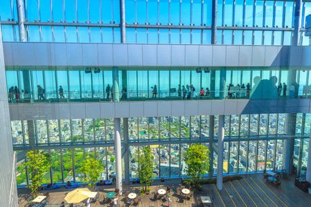 Osaka, Japan - April 30, 2017: tourists looking Osaka skyline from the large windows of observation deck at the top of Abeno Harukas, the tallest skyscraper in Japan.のeditorial素材