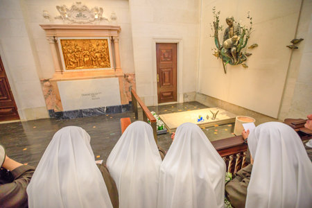 Fatima, Portugal - August 15, 2017: nuns pray before one of graves of shepherds who saw the apparitions of Virgin Mary, inside Basilica of Our Lady of Fatima, the biggest pilgrimage Site in Portugalのeditorial素材