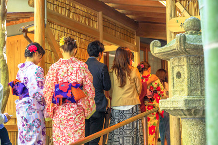 Kamakura, Japan - April 23, 2017: row of Japanese people in kimono at the entrance to green tea, for...
