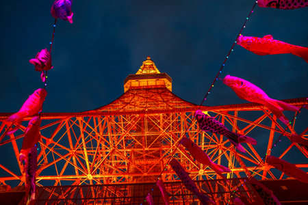 Tokyo, Japan - April 23, 2017: colorful Koinobori at Tokyo Tower by night. Koinobori are carp-shaped wind socks traditionally flown in Japan to celebrate Childrens Day. Focus on Tokyo Tower.のeditorial素材