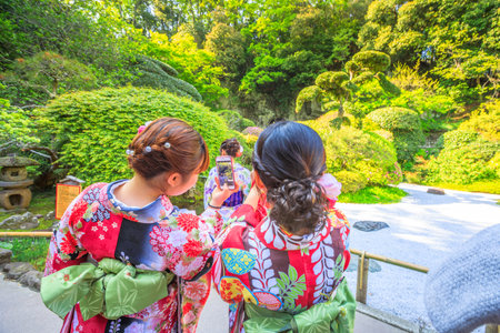Kamakura, Japan - April 23, 2017: Japanese women wearing Japanese traditional kimono take photo with smartphone at japanese zen garden inside Take-dera Temple in Kamakura.のeditorial素材