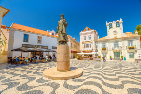 Cascais, Portugal - August 6, 2017: King Peter I Statues in Outubro Square, historic Cascais center, the most popular holiday destination on Lisbon coast.Typical Portuguese mosaic flooring. Blue sky.のeditorial素材