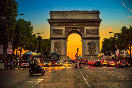 Paris, France - July 2, 2017: square at Champs Elysees street and center of Place Charles de Gaulle with Arch of triumph at twilight with traffic street. Arc de Triomphe at blue hour in Paris.のeditorial素材