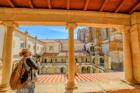 Photographer with stabilizer and professional camera takes photos at cloister of Santa Barbara. The...