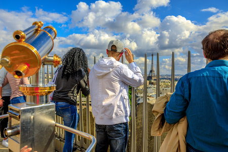 Paris, France - July 2, 2017: people looking skyline of Paris from top of Arc de Triomphe. Aerial view of Tour Eiffel in the distance. Landmark in Paris, France, Europe.のeditorial素材