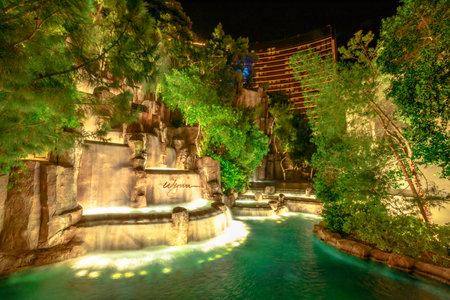Las Vegas, Nevada, United States - August 18, 2018: Wynn Las Vegas Waterfall Fountain. The Wynn is Resort Hotel 5-star casino in Las Vegas Strip. Falls in the garden outdoors illuminated by night.のeditorial素材
