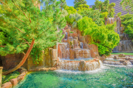 Las Vegas, Nevada, United States - August 18, 2018: closeup of Wynn Las Vegas Waterfall Fountain in the garden outdoors in blue sky day. The Wynn is Resort Hotel 5-star casino, Las Vegas Strip.のeditorial素材