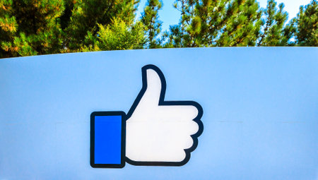 Menlo Park, California, United States - August 13, 2018: Facebook Like logo isolated from the sign at entrance to Facebook Headquarters, in Hacker Way, Silicon Valley. The Facebook Like Button sign.のeditorial素材