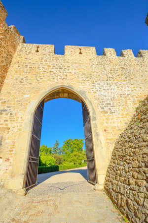 Tomar, Portugal - August 10, 2017: Sun door in Tomar Fortress, Portugal, Unesco Heritage. Tomar convent-fortress was part of a defensive system created by Knights of Hordes of the Templars. Summer season, blue sky. Vertical shot.のeditorial素材