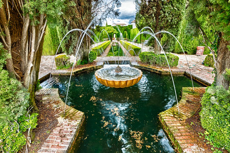 Granada, Andalusia, Spain - circa April 2016: Close up of fountain in the famous avenue of cypress trees, Generalife gardens near Alhambra complex, Granada, Andalucia, Spain, one of the most beautiful in the world and is a Unesco heritage.のeditorial素材