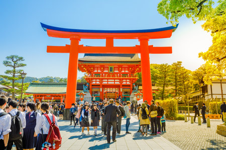 Kyoto, Japan - April 28, 2017: Red Torii gates at Fushimi Inari Taisha with tourists and Japanese students. Fushimi Inari is the most important Shinto sanctuary.のeditorial素材