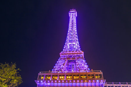 Macau, China - December 8, 2016: the pink lights on Macau Eiffel Tower, icon of The Parisian, a luxury Resort Hotel Casino in Cotai Strip, by night.のeditorial素材