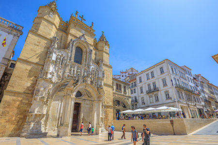 Coimbra, Portugal - August 14, 2017: people in Praca 8 de Maio square with popular main facade of Santa Cruz Monastery and Church. Historic medieval district in Coimbra in Central Portugal, Europe.のeditorial素材