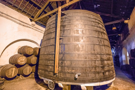 Porto, Portugal - August 13, 2017: cellar with traditional big wooden wine barrels. Ferreira Winery in Vila Nova de Gaia, one of the most popular wine tasting tours.Vila Nova is famous for its cellarsのeditorial素材