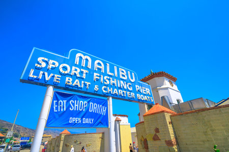 Malibu, California, United States - August 7, 2018: historic Malibu Pier Sign, one of the longest piers in California, on Pacific Coast Highway, 11 miles west of Santa Monica. Sunny day, blue sky.のeditorial素材