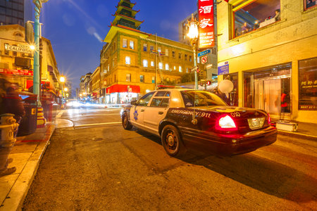 San Francisco, California, United States - August 16, 2016: police car on a street in Chinatown of San Francisco by night. Urban street view. Blue hour shot.のeditorial素材