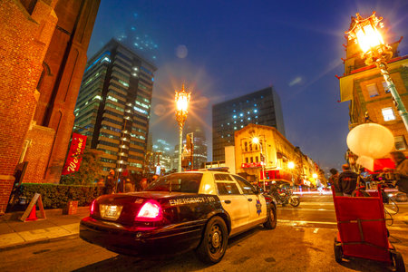 San Francisco, California, United States - August 16, 2016: film crew shooting a fake police car in Chinatown of San Francisco by night. Urban street view.のeditorial素材