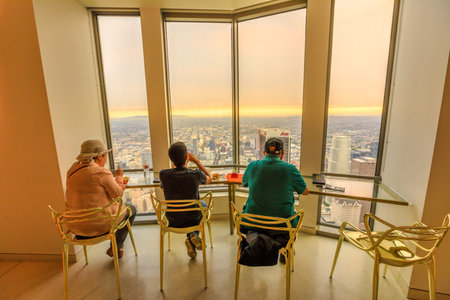 Los Angeles, California, United States - August 9, 2018: people look the sunset skyline over Los...