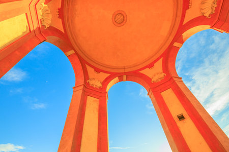 Bottom view of arcades of Sanctuary of Madonna di San Luca on blue sky. Architectural details of...