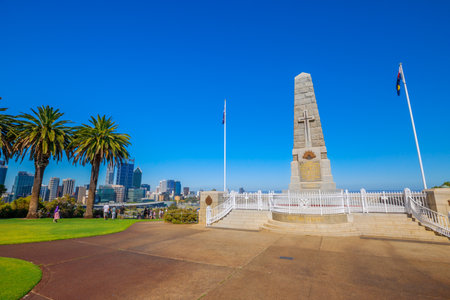 Perth, Australia - Jan 3, 2018: State War Memorial on Mount Eliza in Kings Park. Perth cityscape on background. Kings Park is a large park in Perth by Western Australian Botanic Garden. Blue sky.のeditorial素材
