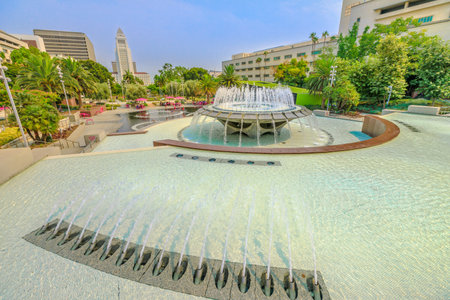 Los Angeles, California, United States - August 9, 2018: Water splash at memorial fountain in Grand Park, Downtown of LA. City Hall on background. Sunny day in blue sky. Urban summer cityscape.のeditorial素材