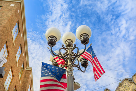 Typical vintage gas lamp with american flag, symbol of old historic victorian Gaslamp Quarter, in...