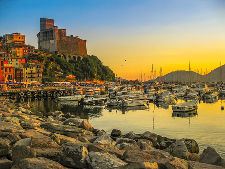 Cliff of Lerici Italian city at sunset. Gulf of Poets and San Giorgio castle on the background at in La Spezia Ligurian Coast of Italy.の写真素材