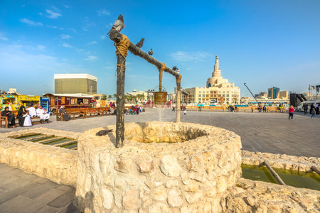 Doha, Qatar - February 20, 2019: pigeons at old well fountain, famous landmark at Souq Waqif. Middle...