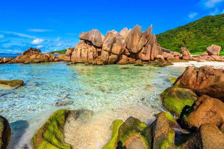 Aerial landscape of natural pool in La Digue, Seychelles Islands. Turquoise calm waters of swimming pools at popular Anse Cocos near Grand Anse and Petite Anse protected by rock formations.の写真素材